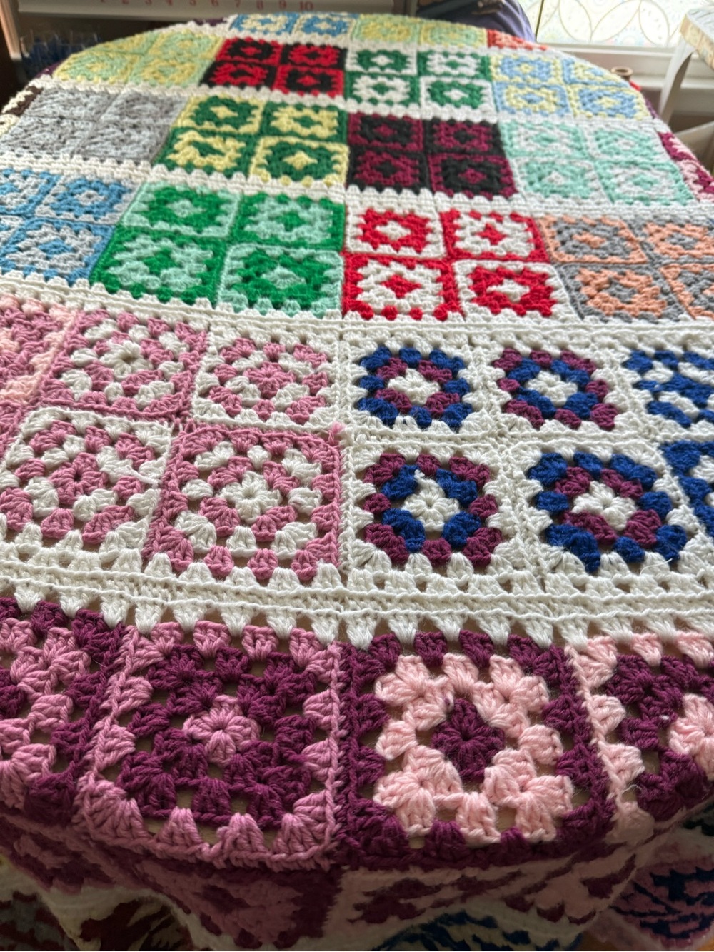 handcrafted multicolored crocheted granny square throw afghan blanket.